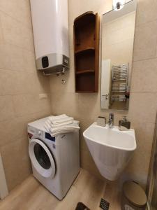 a bathroom with a washing machine and a sink at Apartmani Tip-Top in Tivat