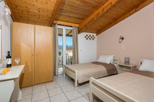 Postel nebo postele na pokoji v ubytování Hotel Tassia for families & couples - Apartments