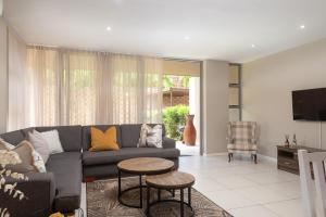 a living room with a couch and a table at Zimbali Wedge Unit 42 in Ballito