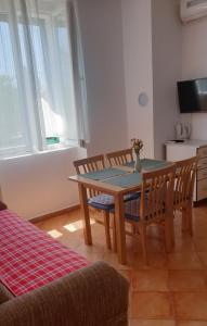 a dining room with a table and two chairs at Apartmani Paron Šime in Seline