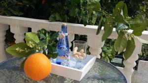 an orange and bottles and glasses on a table at Dimitra's Sea-Crafts Boutique Studios in Kalyves