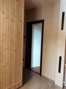 an open door to a room with wooden walls at Jaszczurowa Apartament II in Jaszczurowa