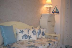 a bedroom with a bed with pillows and a lamp at Dimitra's Sea-Crafts Boutique Studios in Kalyves