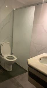 a bathroom with a toilet and a sink at شاليه درة العروس in Durat Alarous +40 photos