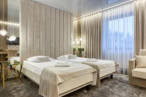 Postel nebo postele na pokoji v ubytování Hotel & Spa Biały Dom