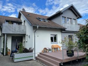 a house with a wooden deck in front of it at Ferienwohnung Nussbaum-Nest in Hausen