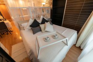 a hotel room with two beds and a table at Nastasi Hotel & Spa in Lleida