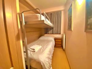 a small room with a bunk bed and a ladder at Pleta de Soldeu 11 4,3 in Soldeu