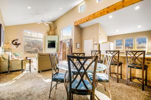 a dining room and living room with a table and chairs at Rim Village D4 in Moab