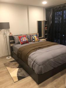 a bedroom with a large bed with colorful pillows at Marvest Hua Hin flat B 208 3.fl. Betw.Soi 78-80 in Hua Hin