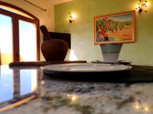 a table with a plate and a cup on it at Mahdia - Baghdadi - Laourient Apartments, restaurant, café in Mahdia
