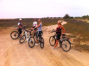 a group of people riding bikes on a dirt road at Mahdia - Baghdadi - Laourient Apartments, restaurant, café in Mahdia