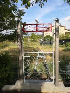 a gate with a bird sitting on top of it at Villa Vecchio Ulivo in Sarconi