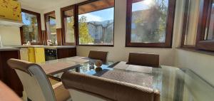 a dining room with a glass table in a kitchen at ALBISTO Dragalevtsi Luxury Apartments in Sofia