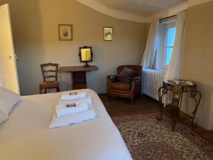 a bedroom with a bed with towels on it at Domaine d'Angouire in Moustiers-Sainte-Marie