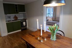 a dining room table with candles on top of it at Vadstena innerstad in Vadstena