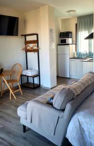 a large bed in a room with a kitchen at Morada 2 in Casas del Cerro