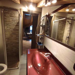 a bathroom with a red sink and a mirror at DGApartments Stella Alpina Livigno in Livigno