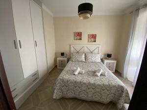a bedroom with a bed with two pillows on it at CASA BODONAL CENTRO R&S in Bodonal de la Sierra