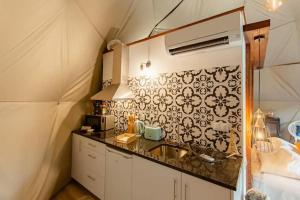 a small kitchen with a sink and a wall at Refúgio das Poldras in Mondim de Basto