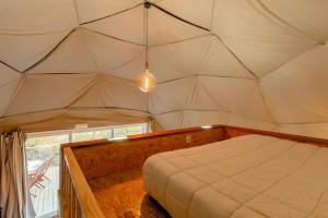 a bed in a room with a canopy over it at Refúgio das Poldras in Mondim de Basto