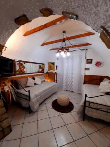 a living room with two beds and a couch at La Tavernetta in Pignola