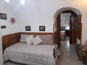 a bedroom with a bed in a room at La Tavernetta in Pignola