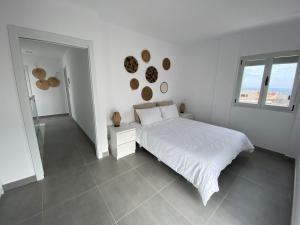 Een bed of bedden in een kamer bij Casa de Playa maravillosa en Taliarte