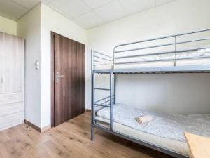 a bedroom with two bunk beds and a door at Pokoje Tanie Spanie in Zator
