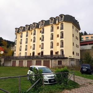 a building with a car parked in front of it at Casa Lorica M&S in Lorica