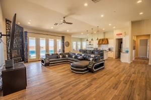 a large living room with couches and a kitchen at 3400 SqFt House W/40Ft Heated Pool/Spa- Strip View in Las Vegas