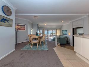 a kitchen and living room with a table and chairs at A Yachtsmans Rest Unit 3 37 Victoria Parade in Nelson Bay