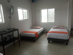 A bed or beds in a room at Olimpia Habitaciones Departamentos