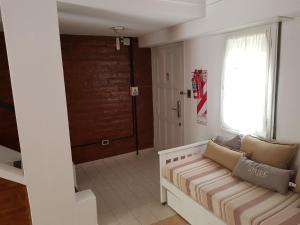 a living room with a couch and a window at Departamentos El Colono Duplex 2 in Viedma