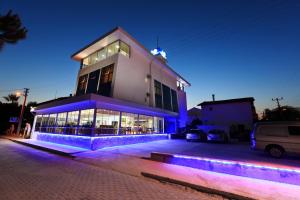 a building with blue lights in front of it at AGZ Hotel in Dikili