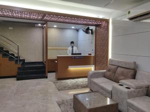 a man standing at a podium in a lobby at century courtyard in Chennai
