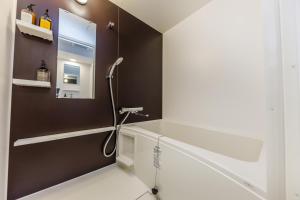 a bathroom with a shower and a sink at HOPETREE OSAKA GRAND in Osaka