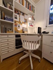 a white desk with a white chair in a room at Avenida General Las Heras in Buenos Aires