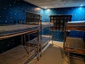 a room with two bunk beds and blue walls at McHanns Place in Antipolo