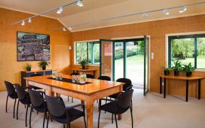 a conference room with a wooden table and chairs at Grasmere Lodge in Cass