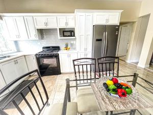 a kitchen with a table with a bowl of fruit on it at Red Hassell Manor in Port Antonio