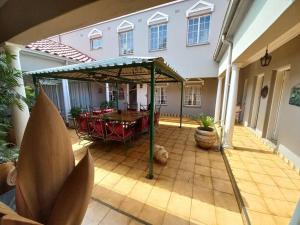 a patio with a table and chairs in a house at Ailani Grey in Benoni