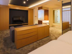 a hotel room with a large television and a bed at Hotel Muso in Kyoto