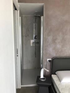 a bathroom with a shower with a bed and a table at Super Villa With Private Pool in Isola Albarella in Isola Albarella