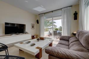 a living room with a couch and a table at Apartamento Costalita in Estepona