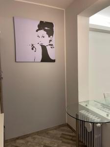 a room with a glass table and a picture on the wall at BONBON in Rovigo
