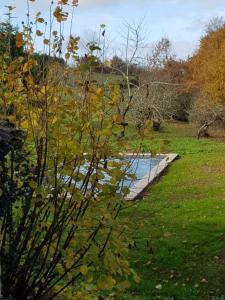 a body of water with a bridge in a field at Gîte loustalneve in Bourg-de-Visa