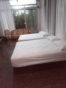 Postel nebo postele na pokoji v ubytování Ri Jing Yuan Homestay