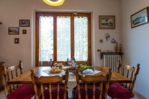 a dining room table with a bowl of fruit on it at Casa Biagiotti in Cortona