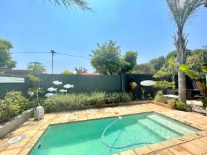 a swimming pool in the backyard of a house at Studio Kay in Benoni